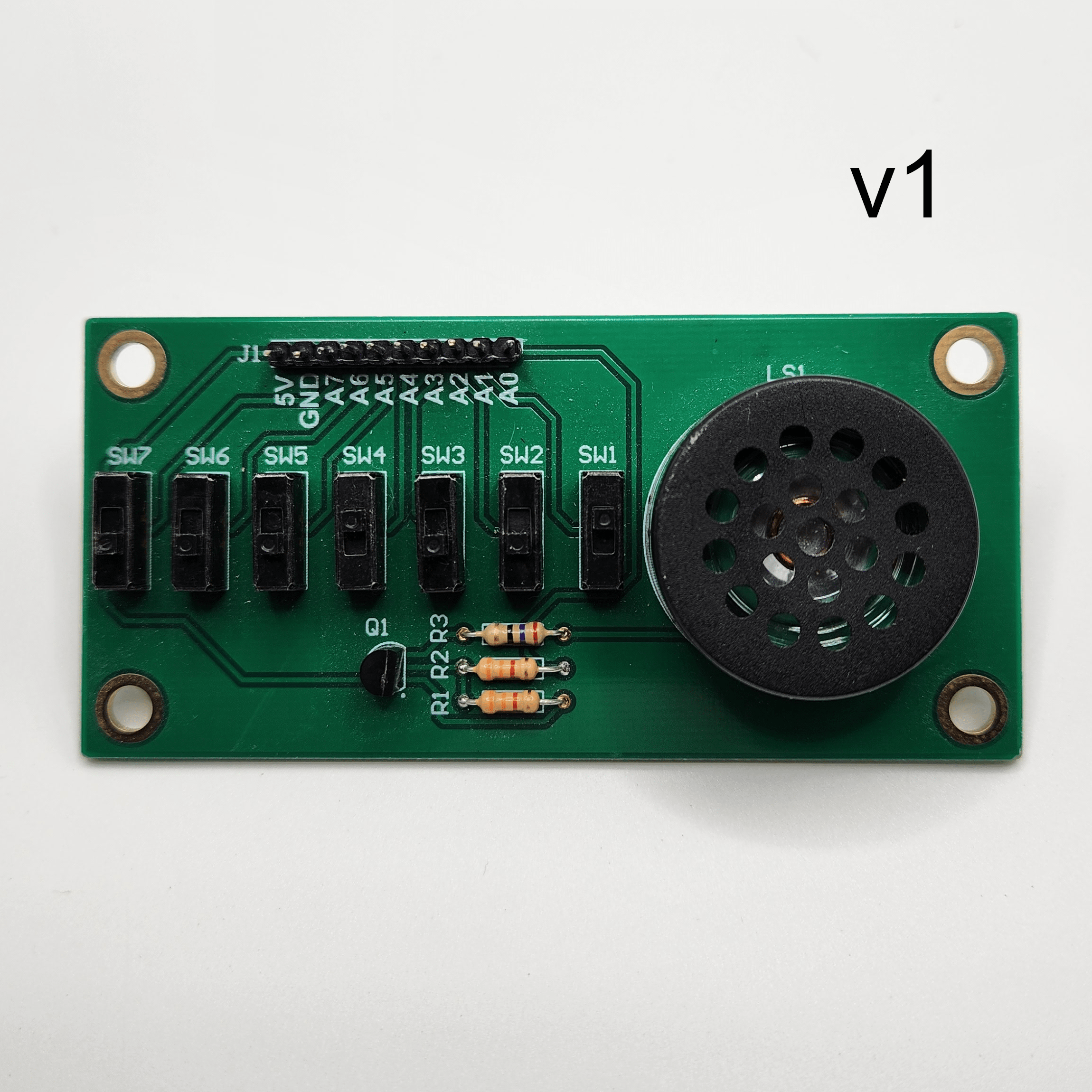 Complete populated Simple Switch and Speaker Demo Board v1 PCB with a text label indicating what version board it is