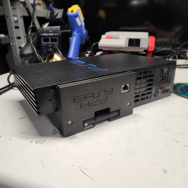 PS2Easy HDD with Network Adapter installed into a black PS2